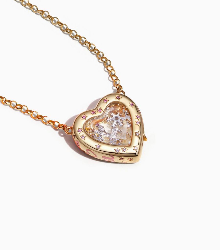 Styled shot of the heart pillow locket by Loquet London with 18k charms