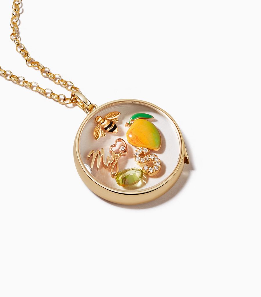 Large round classic locket necklace styled with 18k charms by Loquet London