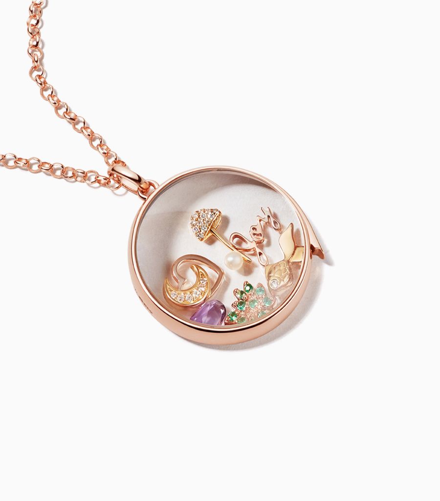 Large classic locket necklace styled with 18k gold charms by Loquet London