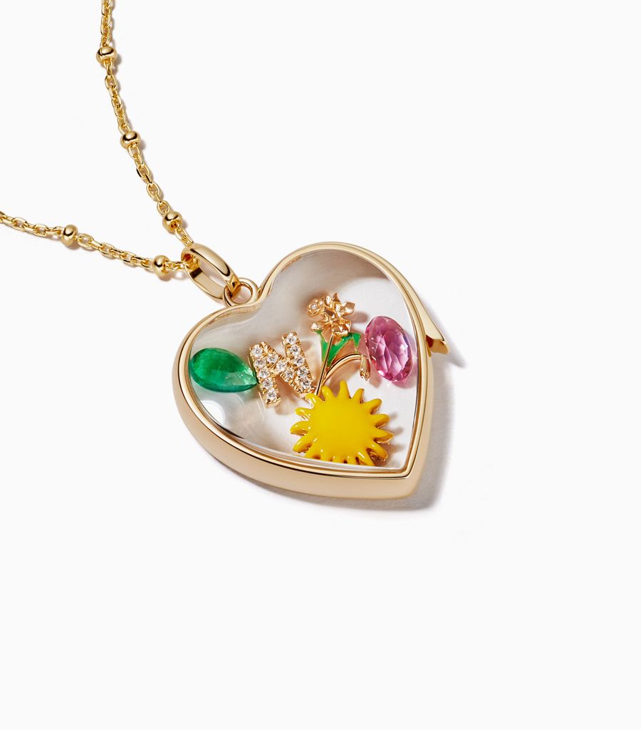 Large yellow gold heart locket necklace styled with 18k charms by Loquet London