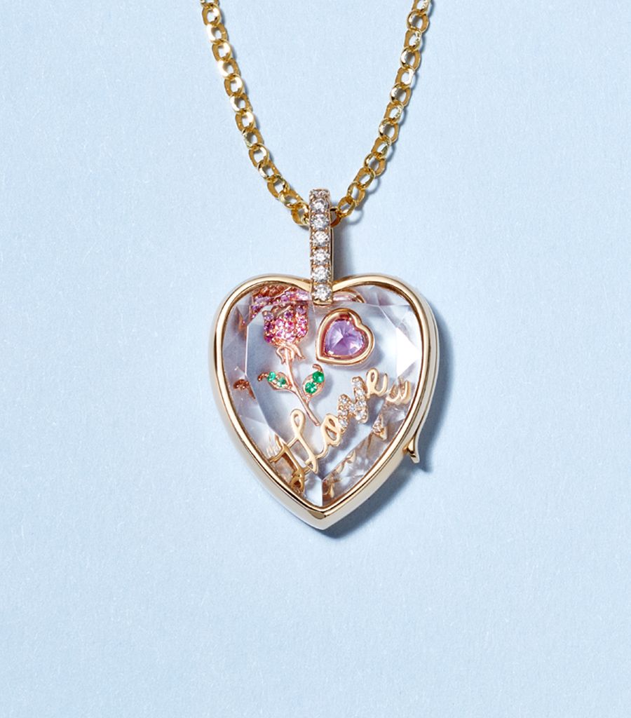 pre-made locket with diamond bail styled with a solid gold chain and a flower rose charm, a pink sapphire heart charm and a love word charm