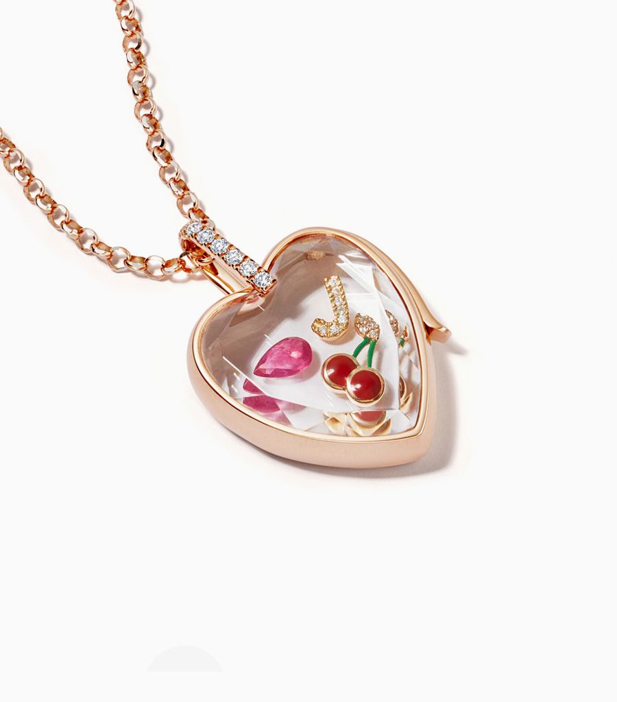 14k rose Gold Diamond heart locket pendant styled with charms and a chain