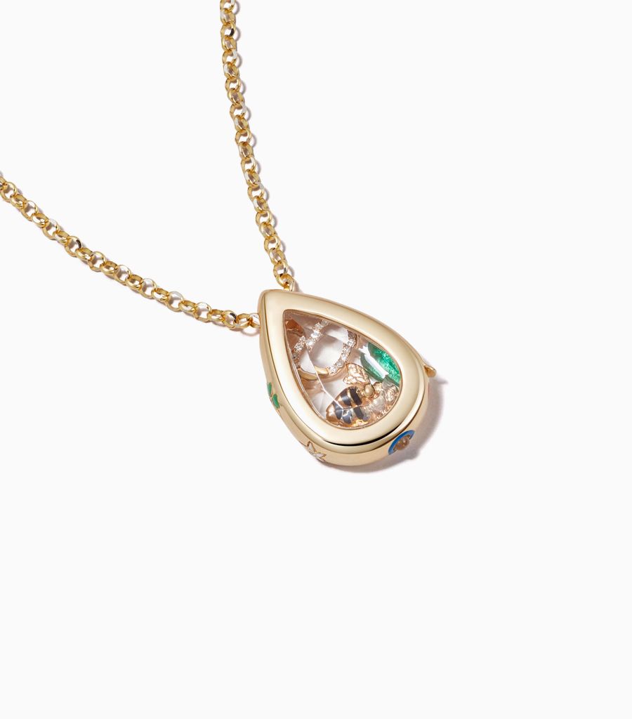 Felicity pillow locket necklace styled with 18k charms by Loquet London