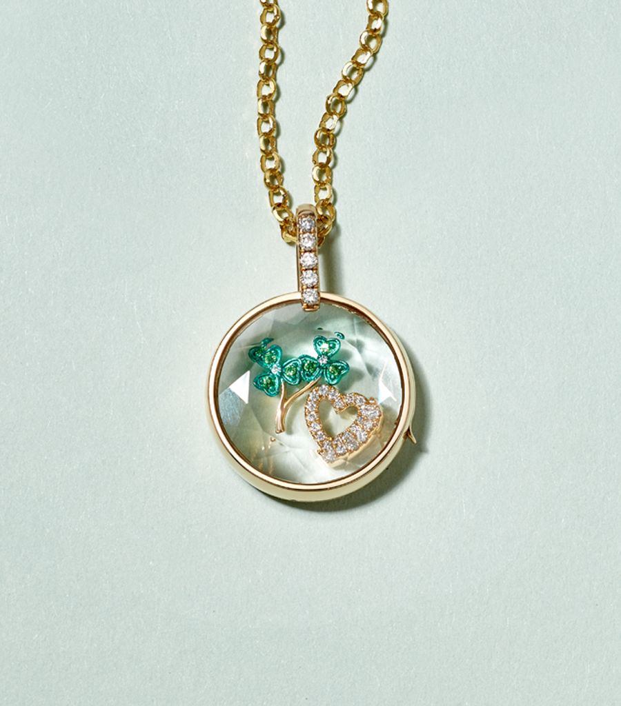 styled locket pre-made with a chain and a clover charm and a diamond heart