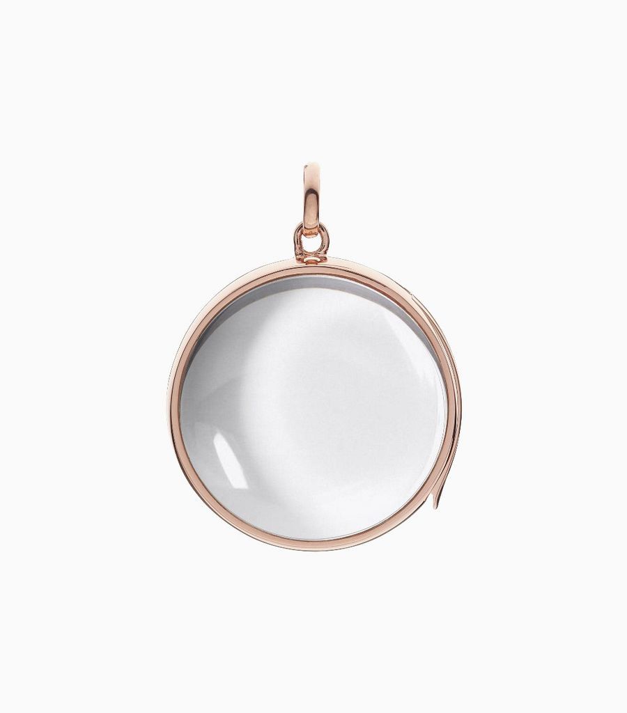9carat rose gold, round shaped locket, set with a bevel edged, crystal glass front and a flat crystal glass back. The locket is designed with a side hindge for secure fastening and has a 24mm drop and a 22.5mm width