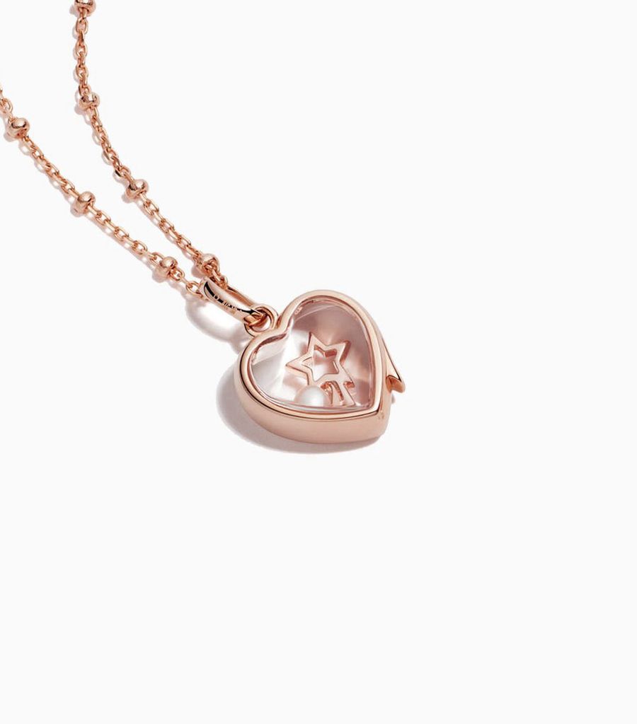 9carat rose gold, heart shaped locket, set with a bevel edged, crystal glass front and a flat crystal glass back. The locket is designed with a side hindge for secure fastening and has a 12mm drop and a 11mm width