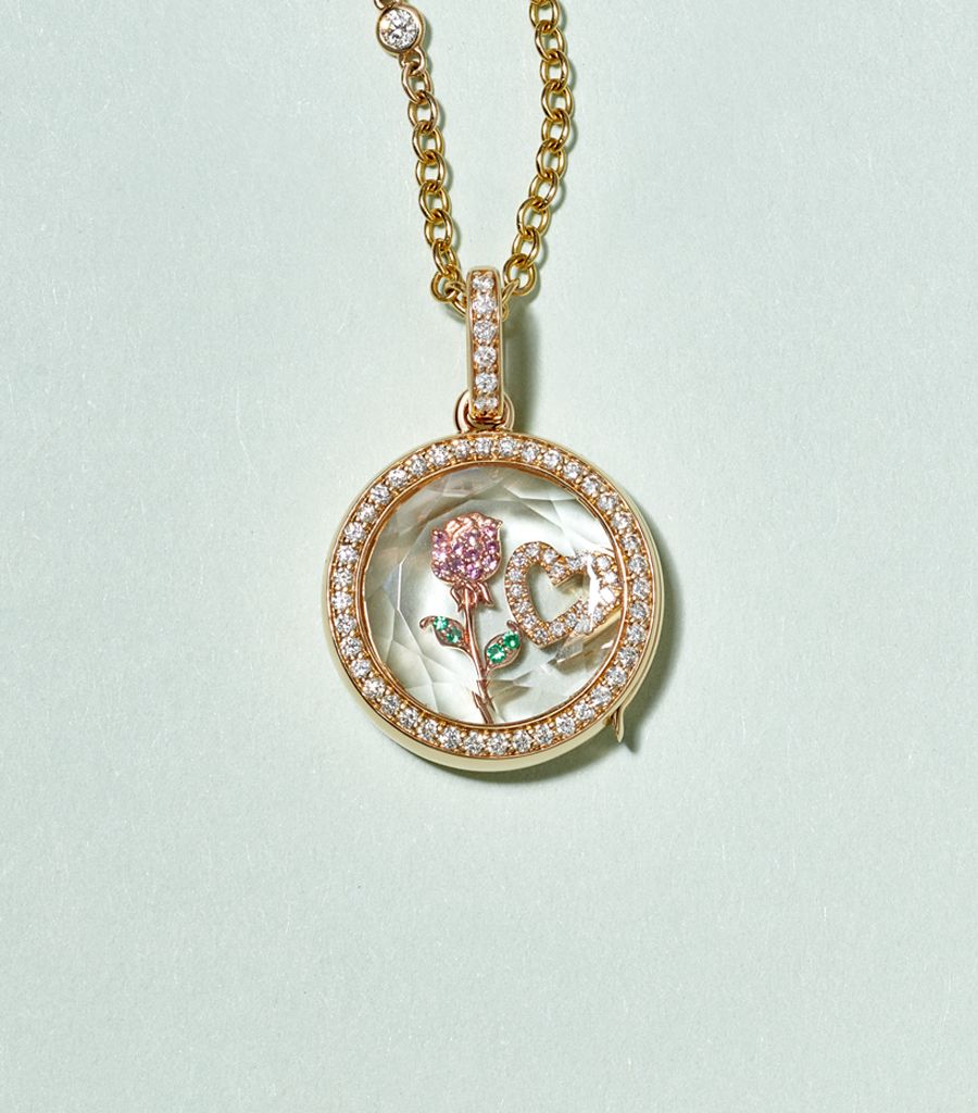 pre-made diamond locket styled with a diamond chain and a diamond heart and a rose flower charm